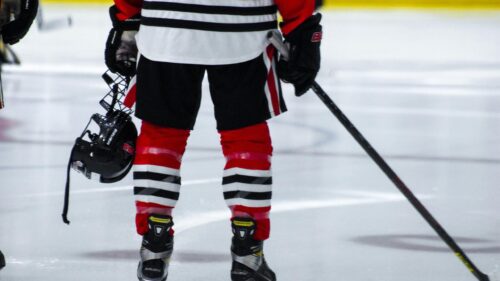 Hockey Player Standing on Ice with Gear Desktop Wallpaper