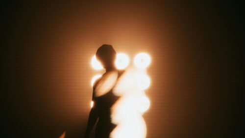 Cinematic Silhouette Against Stage Lights 4K Wallpaper