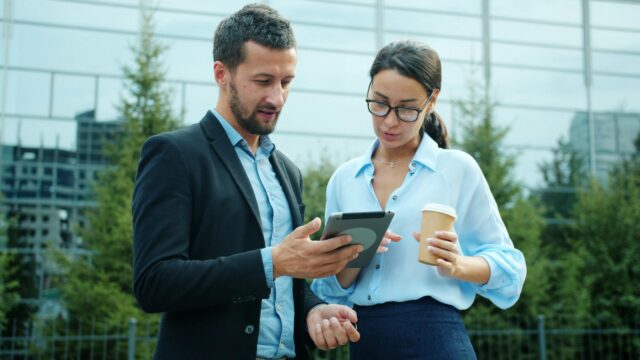 Professional Business Partners Discussing Strategy on Tablet PC Wallpaper