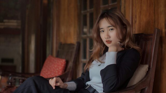 Elegant Asian Woman Sitting in Wooden Chair Desktop Wallpaper