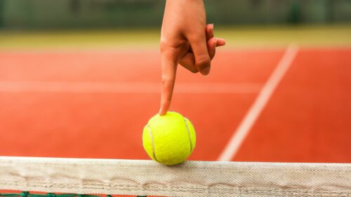 Tennis Ball Balanced on Net Finger Touch High Resolution PC Wallpaper