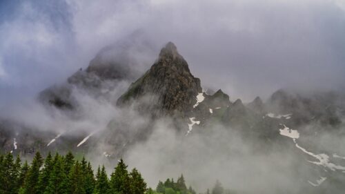Misty Alpine Peak Among Clouds 4K Desktop Wallpaper