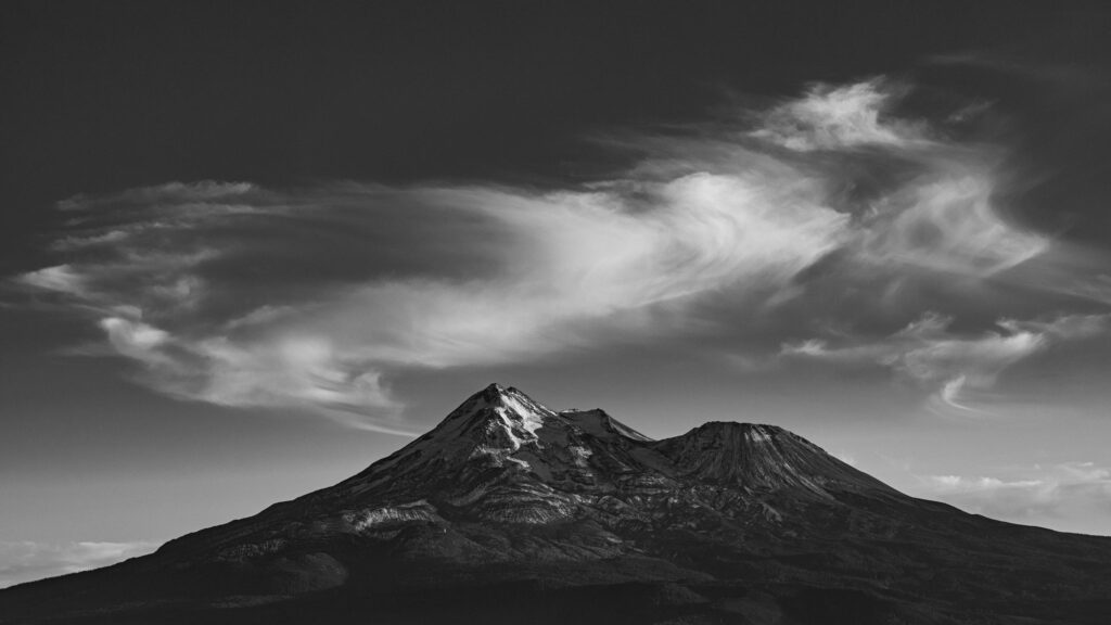 Dramatic Black and White Mountain Peak with Wispy Clouds 4K Wallpaper