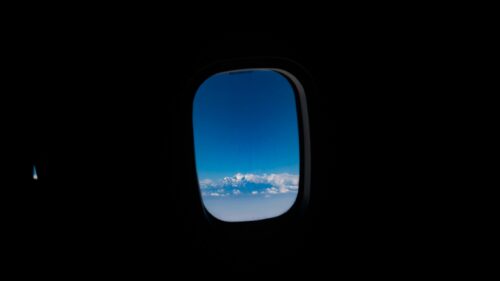 Snow-Capped Mountain Range Seen Through Airplane Window 4K Wallpaper
