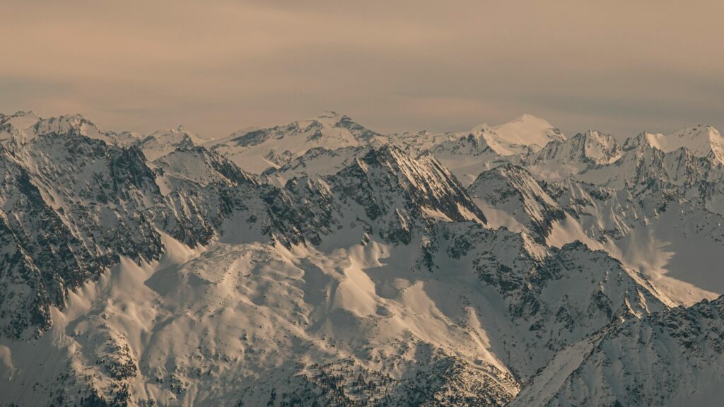 Snow Capped Alpine Peaks at Sunset 4K Desktop Wallpaper