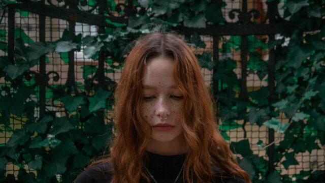 Sad Redhead Girl with Freckles and Nose Piercing 4K Desktop Wallpaper