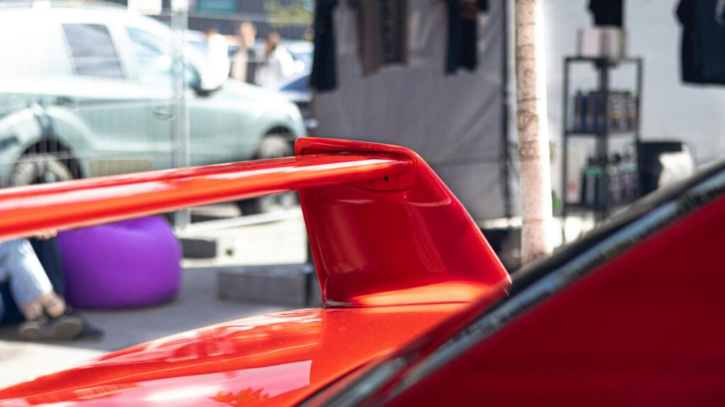 Stunning Red Sports Car Rear Wing Close-Up 4K Wallpaper