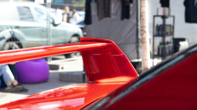 Stunning Red Sports Car Rear Wing Close-Up 4K Wallpaper