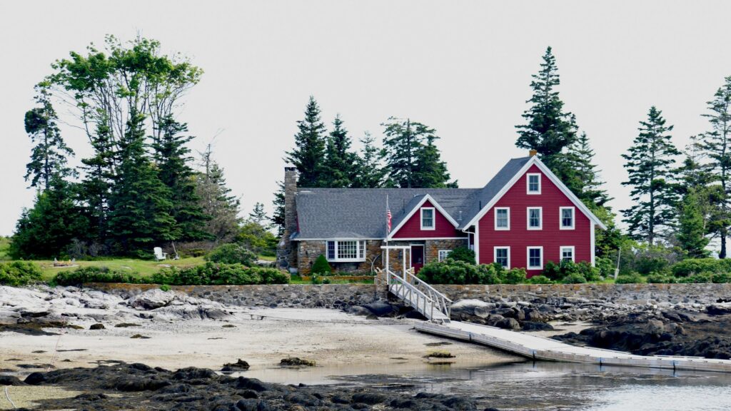 Charming Red Cottage by the Coastal Shore Desktop Wallpaper