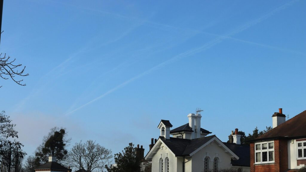 Quaint Country House with Blue Sky and Contrails Desktop Wallpaper