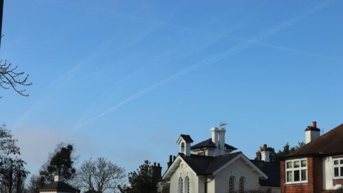 Quaint Country House with Blue Sky and Contrails Desktop Wallpaper