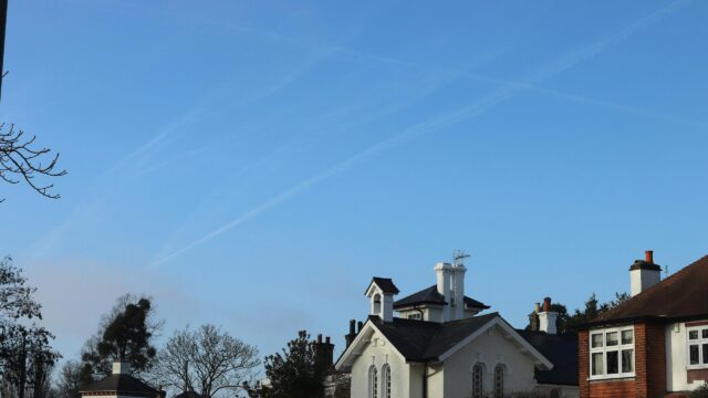 Quaint Country House with Blue Sky and Contrails Desktop Wallpaper