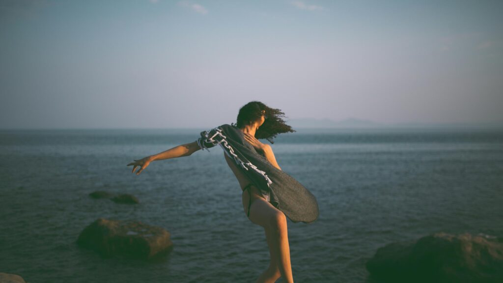 Woman Dancing with Shawl by the Ocean 4K Desktop Wallpaper