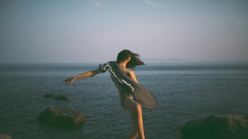 Woman Dancing with Shawl by the Ocean 4K Desktop Wallpaper