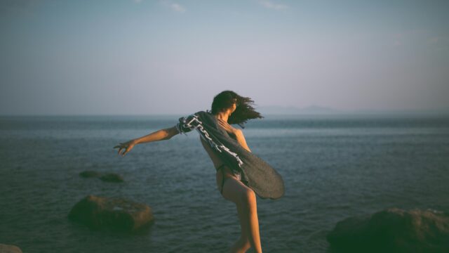 Woman Dancing with Shawl by the Ocean 4K Desktop Wallpaper