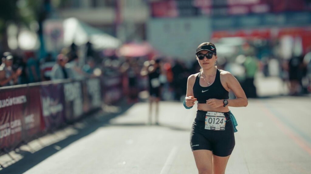 Woman Runner Focused During Marathon Race 4K Desktop Wallpaper