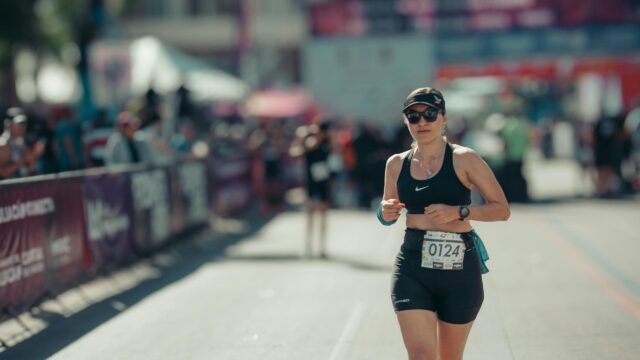 Woman Runner Focused During Marathon Race 4K Desktop Wallpaper