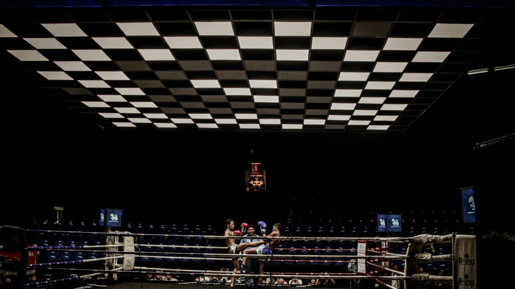 Dramatic Muay Thai Boxing Ring with Checkerboard Ceiling 4K Wallpaper