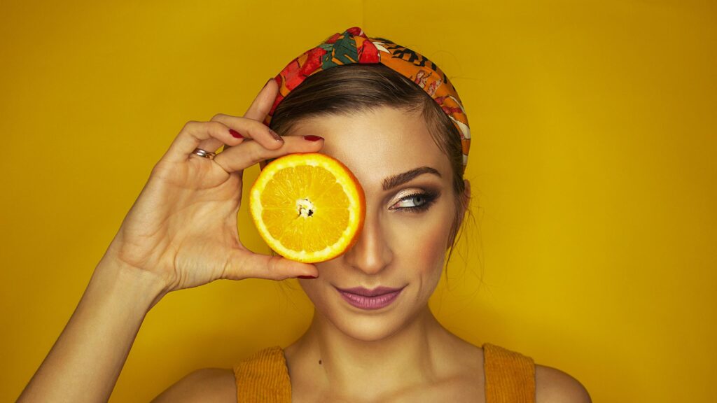 Creative Portrait Woman Holding Orange Slice 4K Desktop Wallpaper