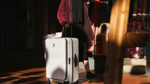 Person Walking with White Travel Suitcase 4K Desktop Wallpaper