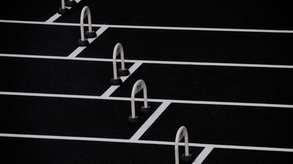 Minimalist White Hurdles on Black Track Texture Desktop Wallpaper