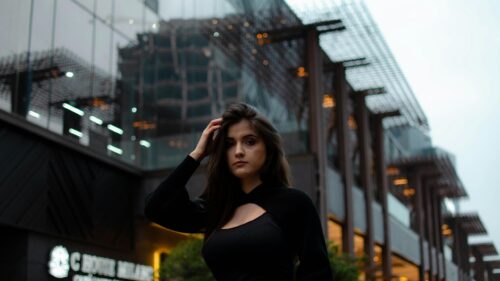 Stunning Portrait of a Brunette Woman in Stylish Black Outfit 4K Wallpaper