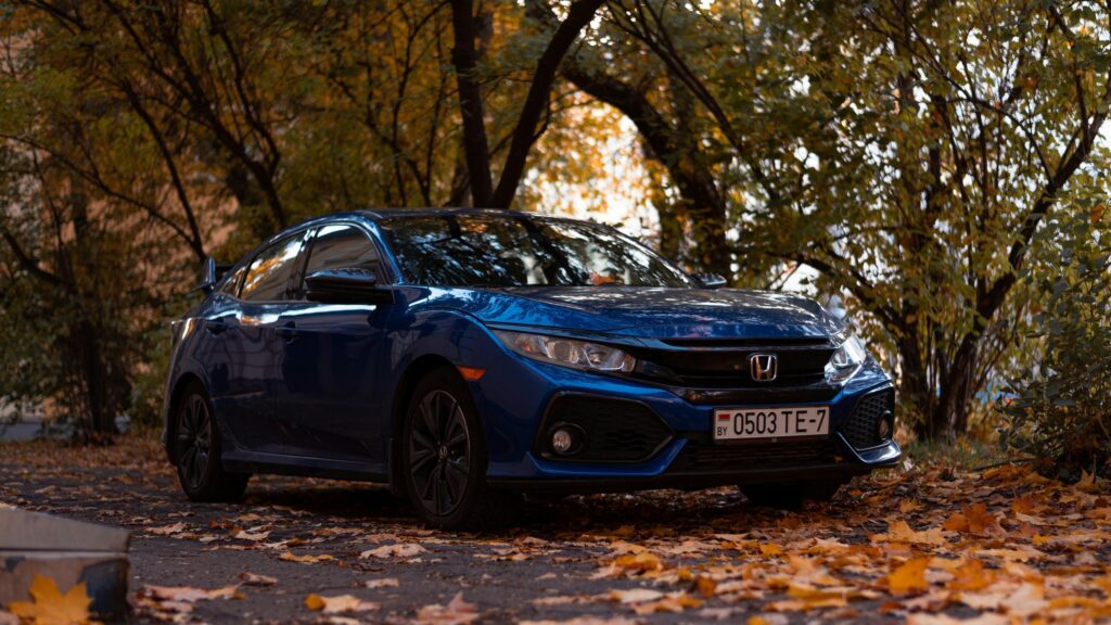 Blue Honda Civic Sports Sedan Parked in Autumn Leaves Desktop Wallpaper