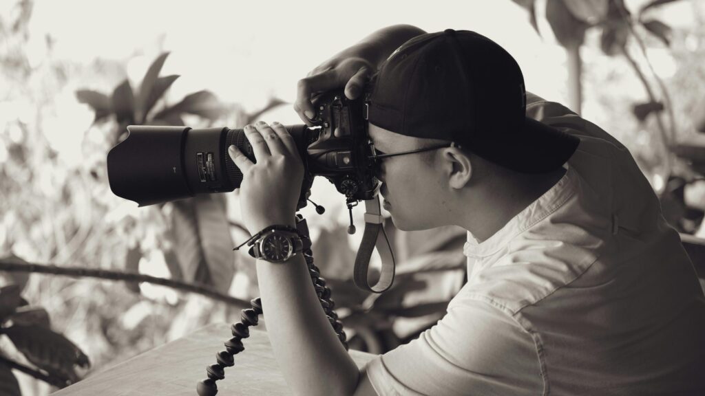 Professional Photographer Focusing Through Camera Lens 4K Wallpaper