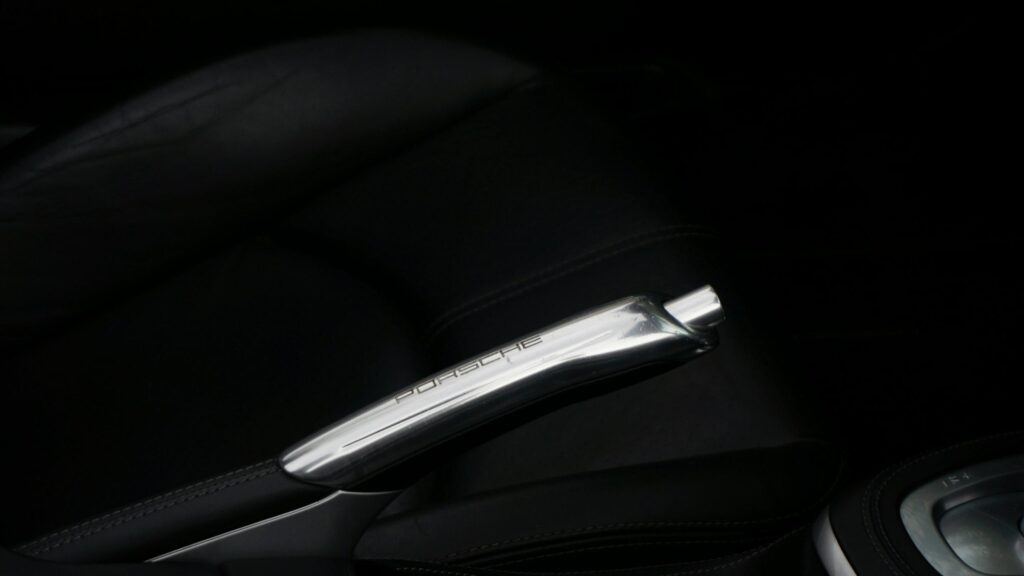 Elegant Porsche Metallic Handbrake Interior Close-up 4K Wallpaper