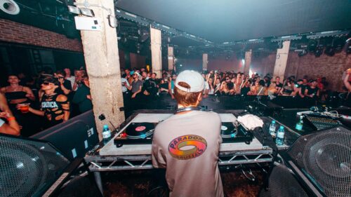 DJ Performing for an Electric Crowd at an Underground Nightclub 4K Wallpaper