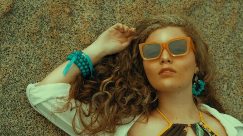 Stunning Young Woman with Curly Hair Lying on Stone Desktop Wallpaper
