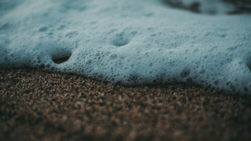Macro Ocean Foam on Sandy Beach Desktop Wallpaper