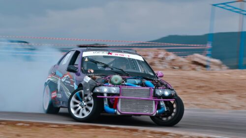 Purple Modified Drift Car Burning Tires on Track 4K Wallpaper