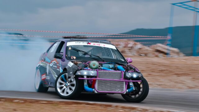 Purple Modified Drift Car Burning Tires on Track 4K Wallpaper