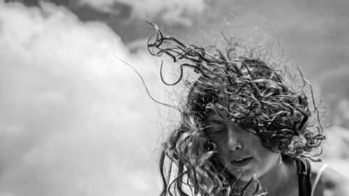 Portrait of a Girl with Windblown Curly Hair Black and White Desktop Wallpaper