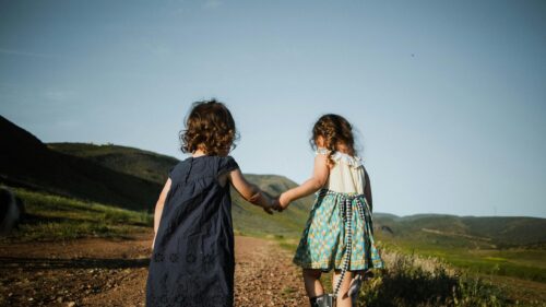 Two Little Girls Holding Hands on Country Road Desktop Wallpaper
