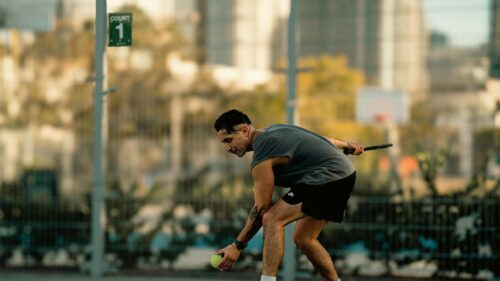 Athlete Picking Up Pickleball on Court 1 Desktop Wallpaper