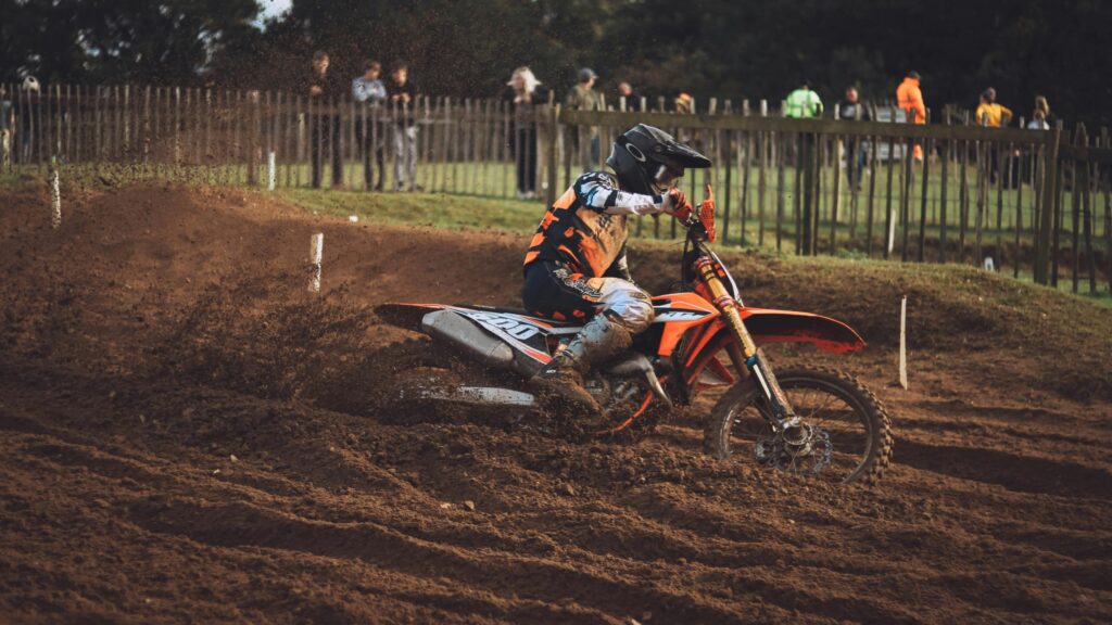 Dirt Bike Motocross Racer Kicking Up Dust Action 4K Wallpaper