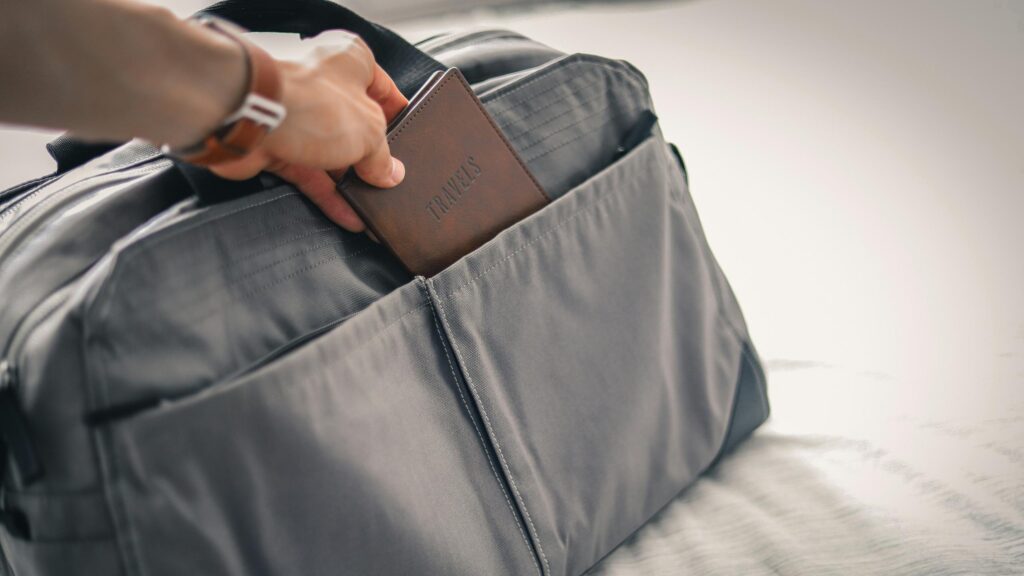 Hand Placing Passport in Travel Bag 4K Wallpaper