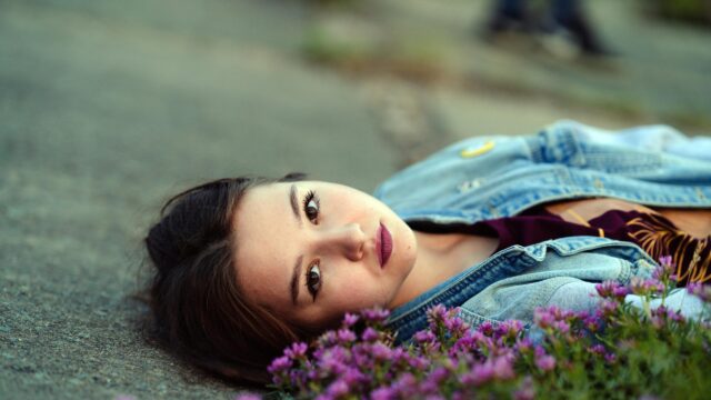 Dreamy Woman Lying Among Purple Flowers Desktop Wallpaper