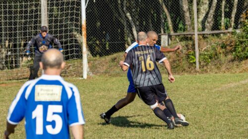 Intense Amateur Soccer Match Action on Grass Field Desktop Wallpaper