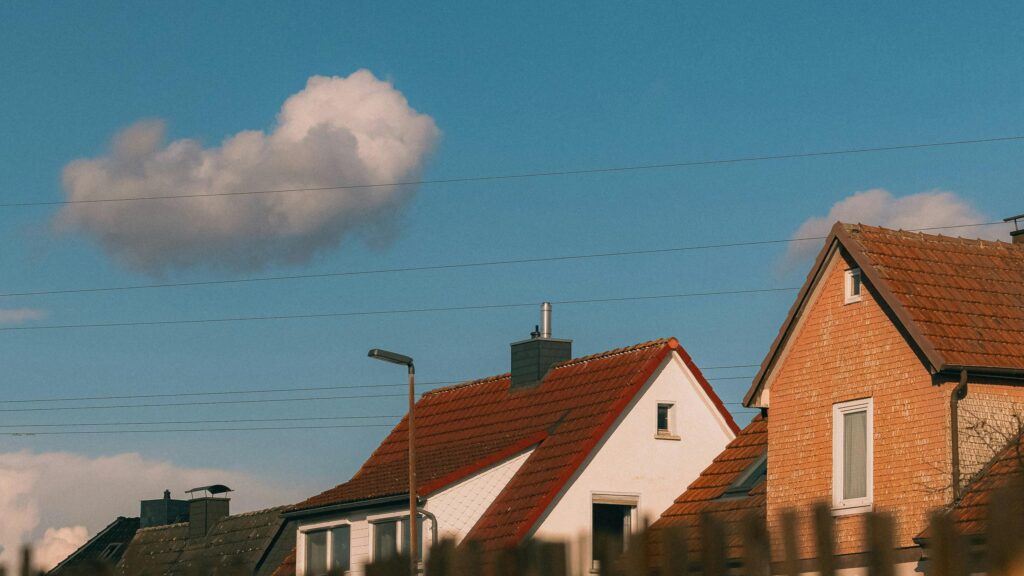 Charming Suburban Houses Under a Sunny Blue Sky Desktop Wallpaper