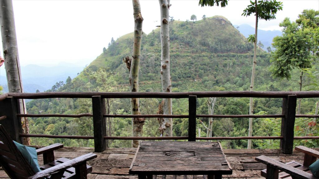 Serene Mountain View from Rustic Wooden Terrace Desktop Wallpaper