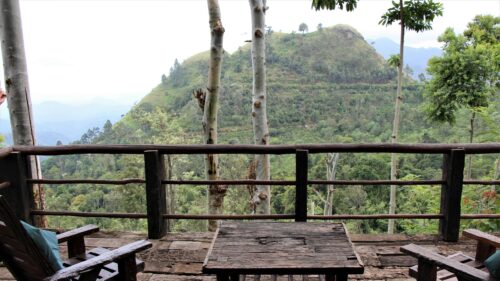 Serene Mountain View from Rustic Wooden Terrace Desktop Wallpaper