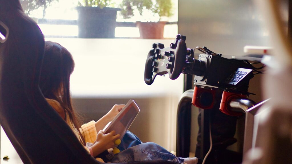 Young Girl Relaxing in a Racing Simulator Cockpit Desktop Wallpaper