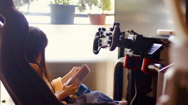Young Girl Relaxing in a Racing Simulator Cockpit Desktop Wallpaper