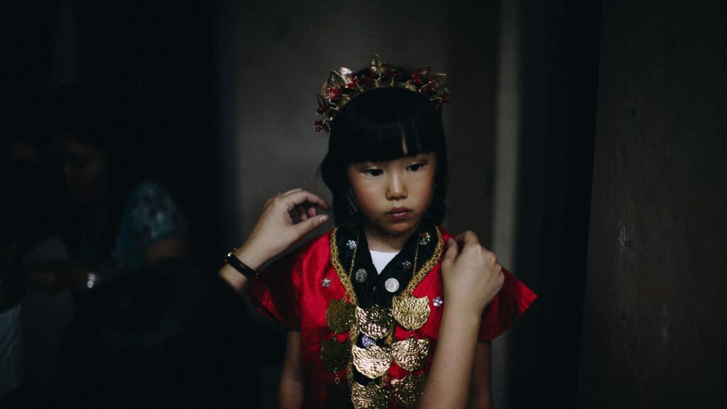Young Girl in Traditional Red Ceremonial Attire Desktop Wallpaper