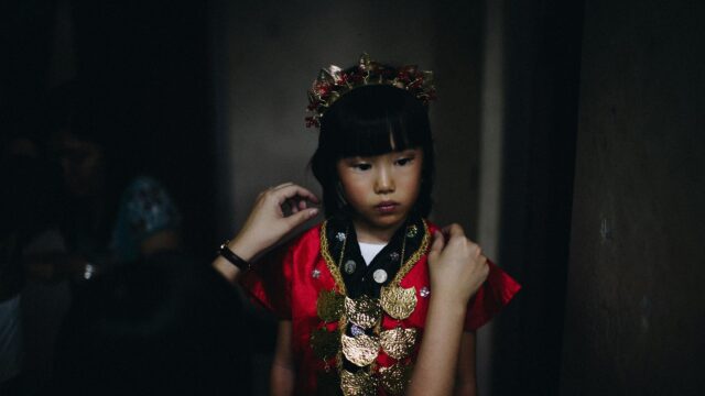Young Girl in Traditional Red Ceremonial Attire Desktop Wallpaper