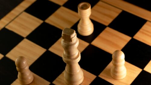 Macro Chess Pieces Focus on Wooden Board 4K Wallpaper