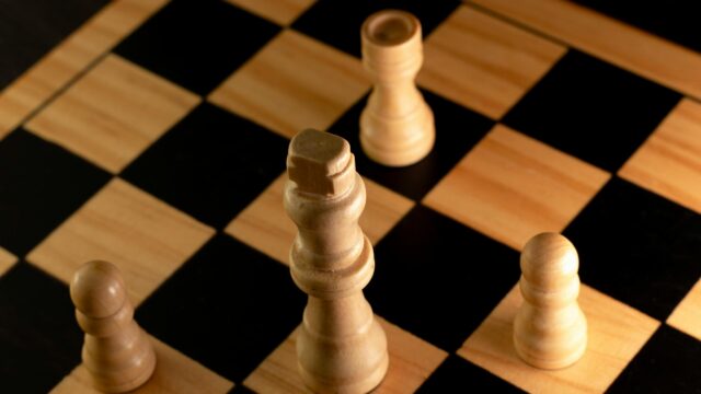 Macro Chess Pieces Focus on Wooden Board 4K Wallpaper